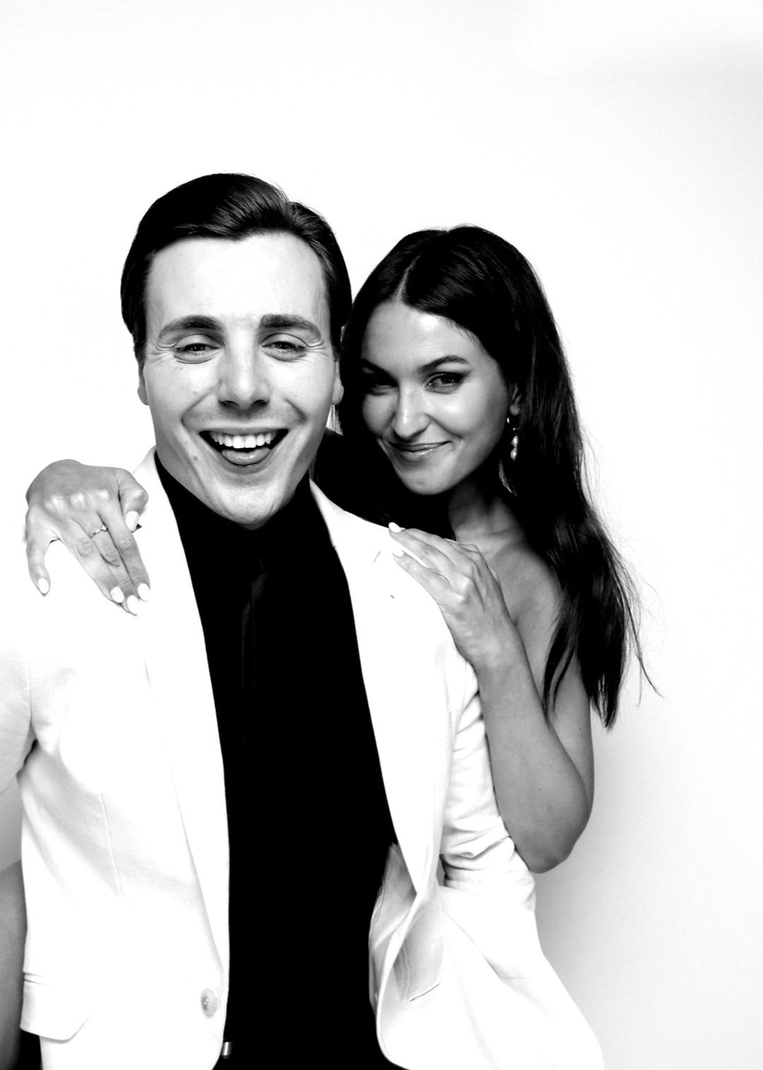 Black-and-white Glam Booth portrait: a man laughing, a friend over his shoulder